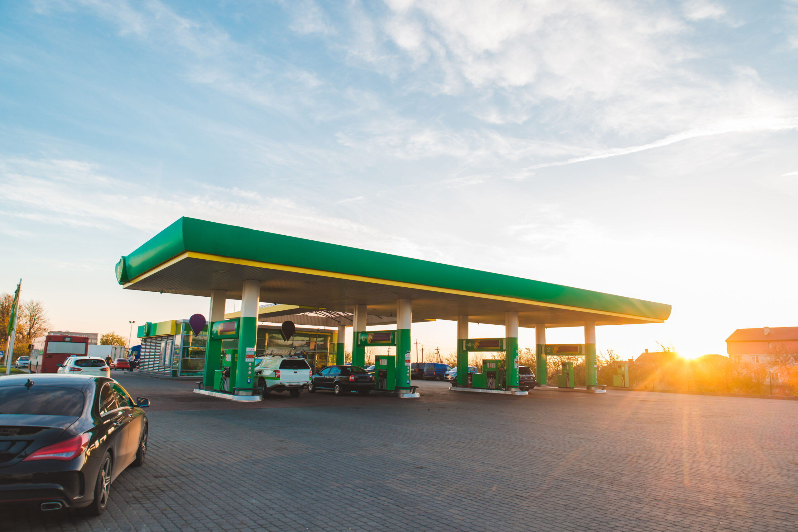 wide view of gas station on sunset copy space