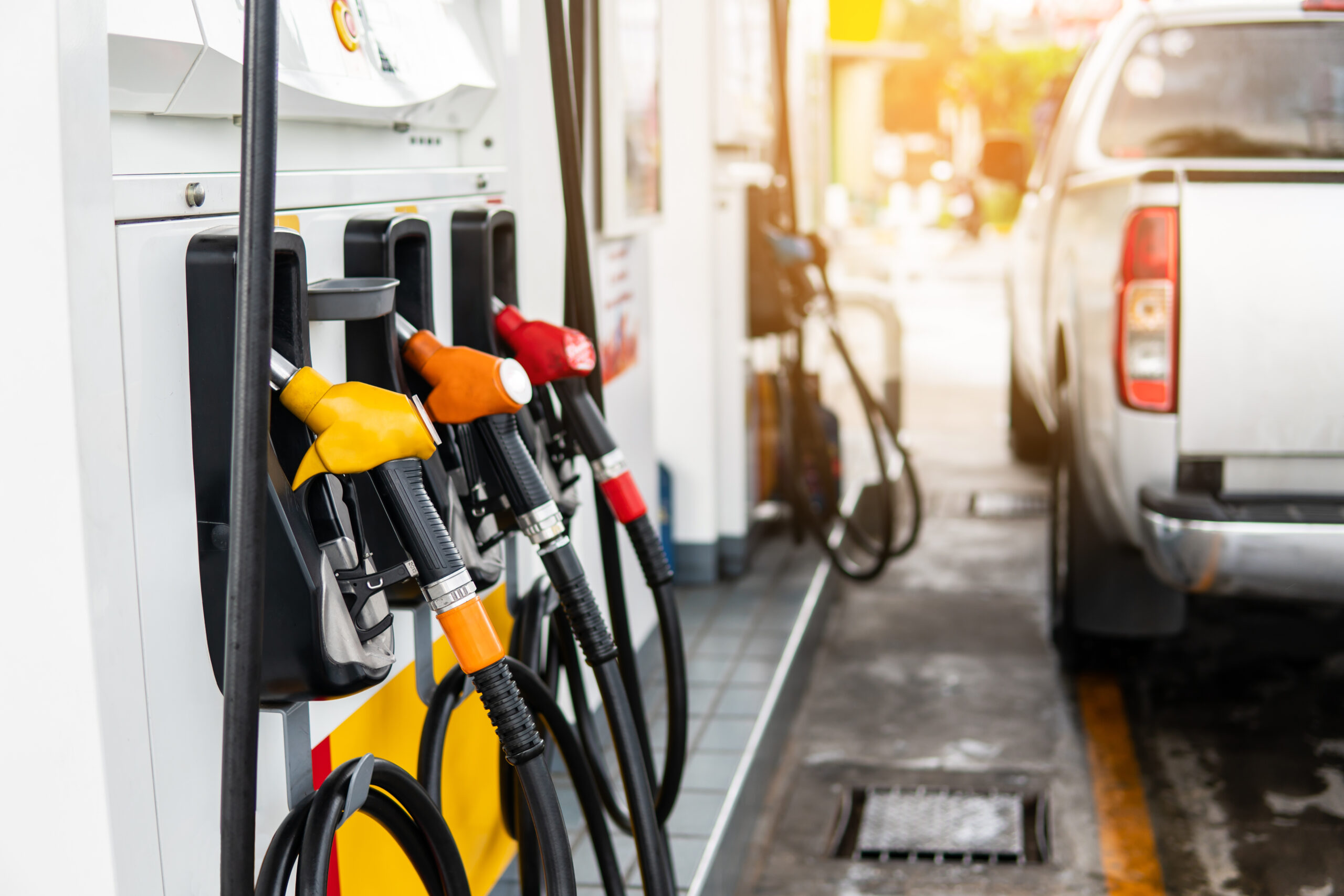 Fuel nozzle to refill fuel in car at gas station.