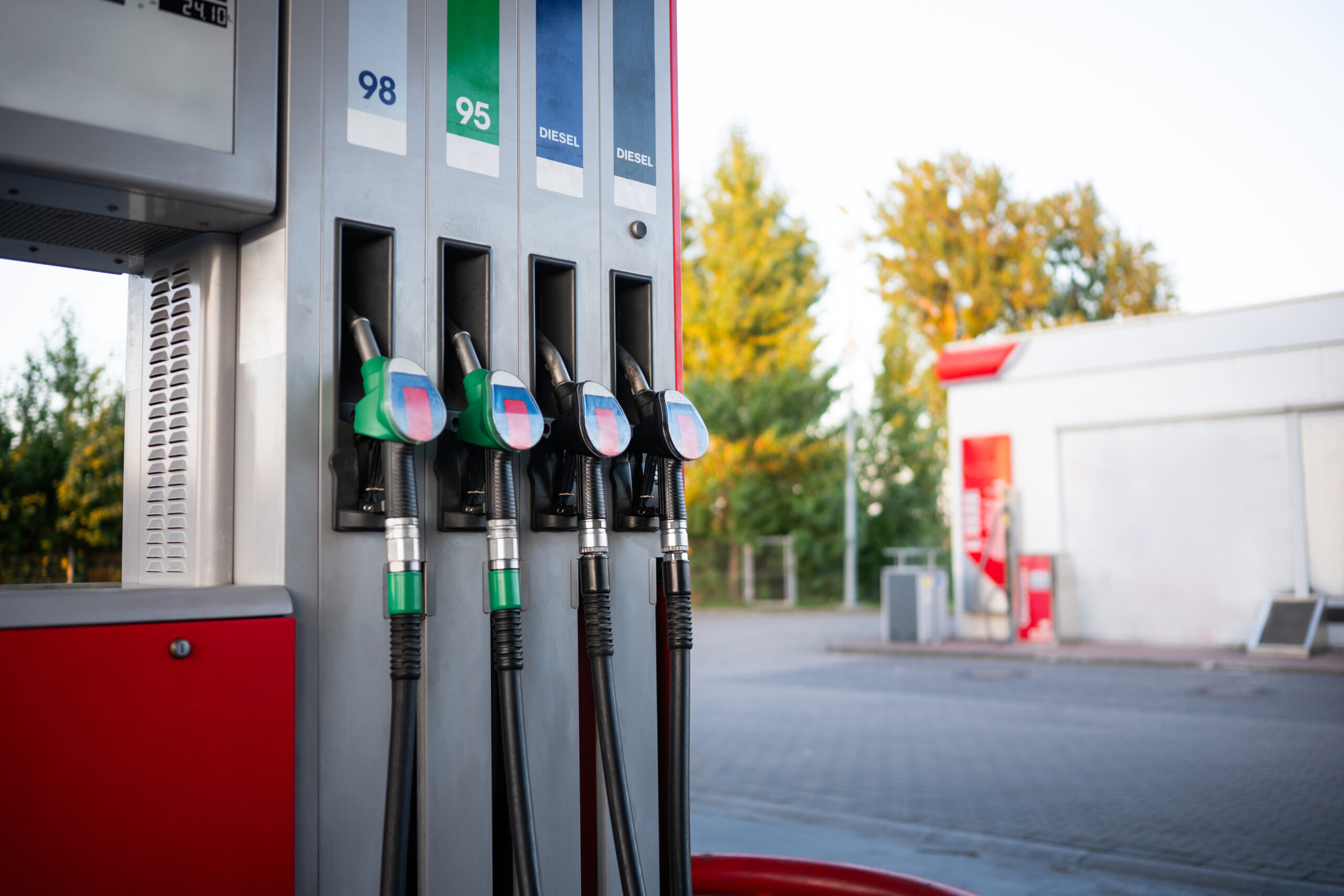 Fuel Pump At A Gasoline Station With Hanging Petrol And Diesel Nozzles
